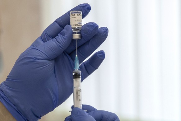 A Russian medical worker prepares a shot of Russia&#039;s Sputnik V coronavirus vaccine in Moscow on Thursday, Dec. 10, 2020. While excitement and enthusiasm greeted the Western-developed coronavirus  ...
