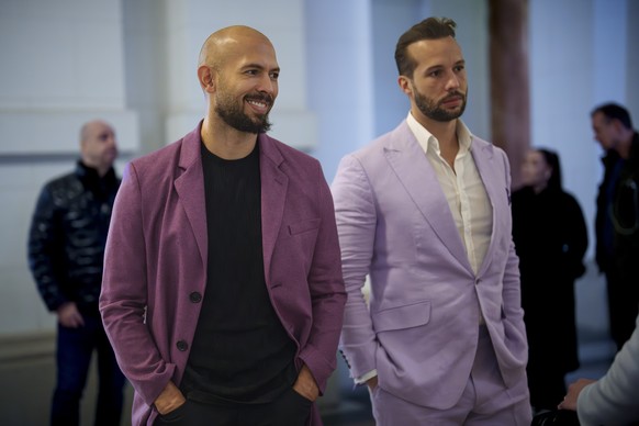 Andrew Tate, left, smiles next to his brother Tristan, right, at the Court of Appeals building in Bucharest, Romania, Tuesday, Dec. 10, 2024. (AP Photo/Vadim Ghirda)