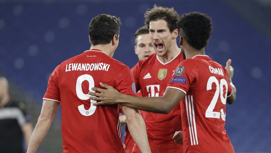 Bayern&#039;s Robert Lewandowski, left, celebrates with his teammates after scoring his side&#039;s opening goal during the Champions League round of 16 first leg soccer match between Lazio and Bayern ...