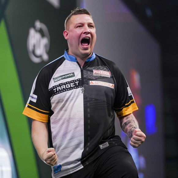 Chris Dobey of England reacts during his quarter final match against Gerwin Price of Wales at the World Darts Championship in London, Wednesday, Jan. 1, 2025.(AP Photo/Alberto Pezzali)
