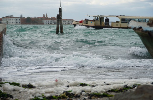 epa10286180 A public transport vaporetto sails in the lagoon south of Venice, in front of the island of San Servolo, while the strong wind from the south creates big waves that make it difficult to ke ...