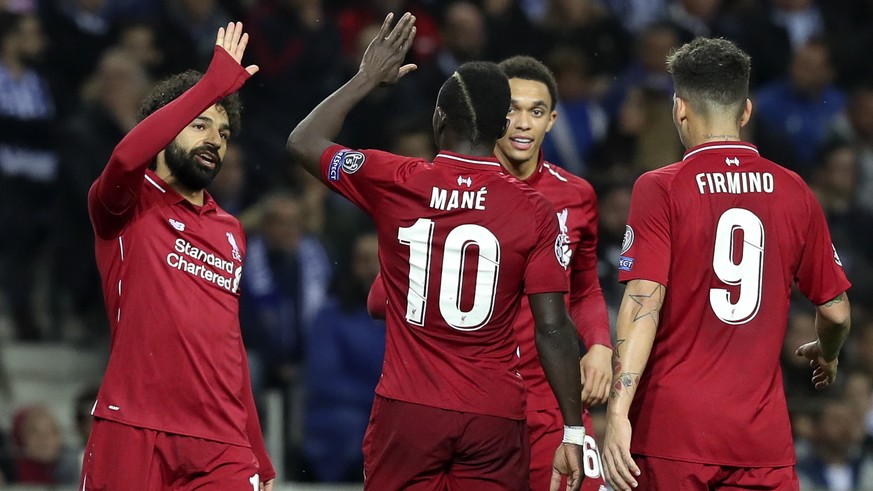 epa07512901 Liverpool&#039;s Mohamed Salah (L) celebrates after scoring a goal against FC Porto during their UEFA Champions League quarter final, second leg, soccer match between FC Porto and Liverpoo ...