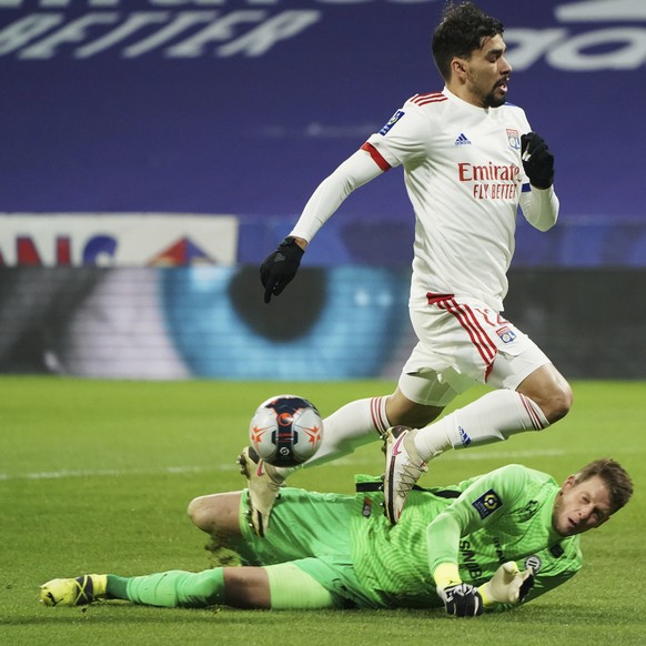 Lyon&#039;s Lucas Paqueta, center, and Montpellier&#039;s goalkeeper Jonas Omlin fight for the ball as Montpellier&#039;s Daniel Congre, right, runs during the French League One soccer match between L ...