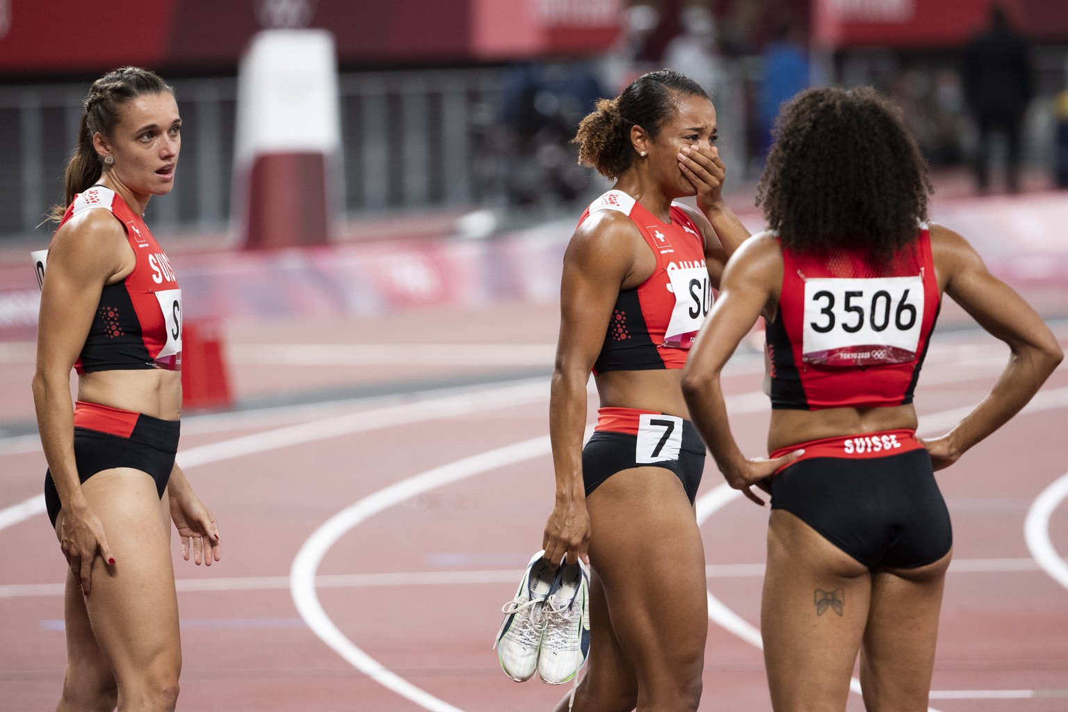 Riccarda Dietsche, Salome Kora and Mujinga Kambundji of Switzerland, from left, react after the women&#039;s athletics 4x100m relay final at the 2020 Tokyo Summer Olympics in Tokyo, Japan, on Friday,  ...