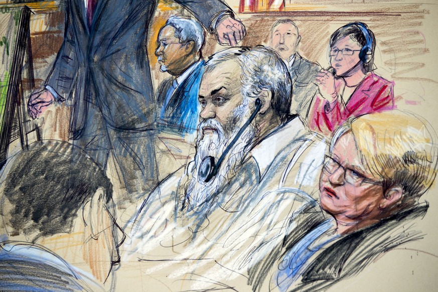 FILE - This Oct. 2, 2017, file courtroom sketch depicts Ahmed Abu Khattala listening to a interpreter through earphones during the opening statement by assistant U.S. attorney John Crabb, second from  ...