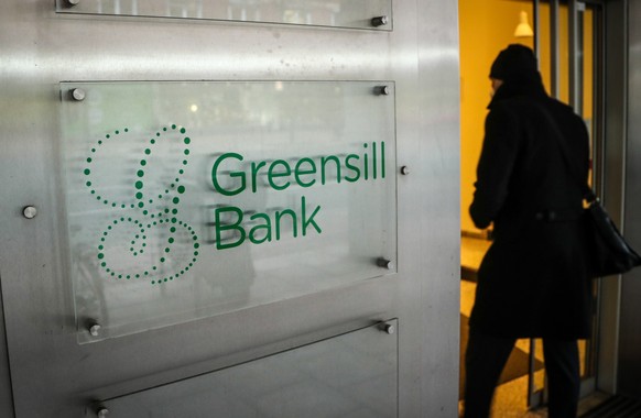 epa09050565 A person enters the Greensill Bank in Bremen, northern Germany, 04 March 2021. The German Federal Financial Supervisory Authority (BaFin) has banned the bank from regular operations on 03  ...