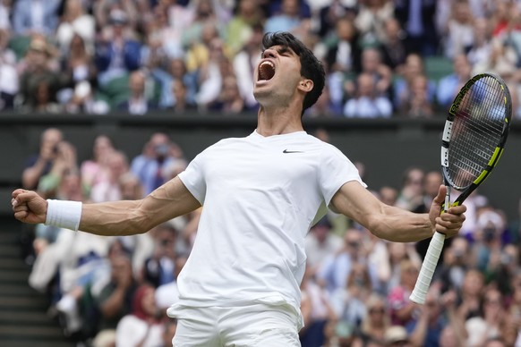Carlos Alcaraz of Spain celebrates after defeating Daniil Medvedev of Russia in their semifinal match at the Wimbledon tennis championships in London, Friday, July 12, 2024. (AP Photo/Kirsty Wiggleswo ...