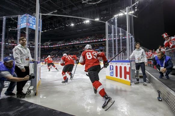 Switzerland&#039;s players defender Michael Fora #45, defender Joel Genazzi #76 and forward Joel Vermin #83, arrive on rink, prior the IIHF 2018 World Championship preliminary round game between Switz ...