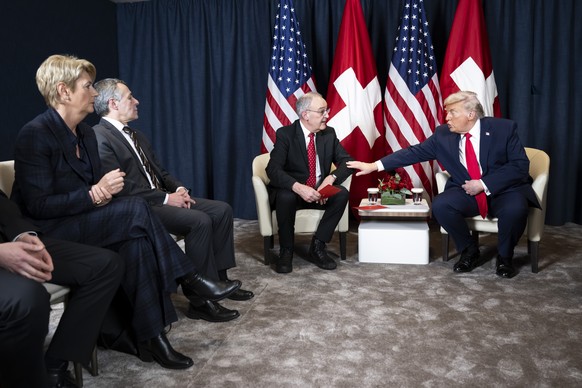 KEYPIX - US President Donald Trump, right, speaks with Switzerland's Federal President Guy Parmelin, center, next to Switzerland's Economy Minister Federal councillor Karin Keller-Sutter lef ...