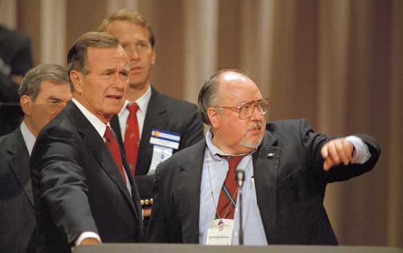 FILE - In this Aug. 17, 1988 file photo, Vice President George H.W. Bush, left, gets some advice from his media advisor, Roger Ailes, right, as they stand behind the podium at the Superdome in New Orl ...