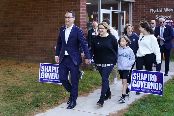 Pennsylvania gubernatorial candidate state Attorney General Josh Shapiro, accompanied by his Lori Shapiro, departs after casting his ballot in the midterm elections in Rydal , Pa., Tuesday, Nov. 8, 20 ...