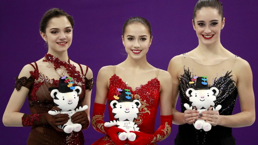 epa06556453 (L-R) Silver medal winner Evgenia Medvedeva of the Olympic Athletes from Russia, Gold medal winner Alina Zagitova of the Olympic Athletes from Russia and Bronze medal winner Kaetlyn Osmond ...