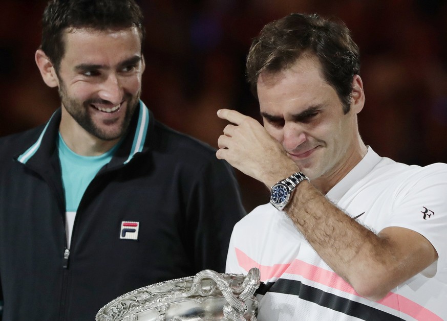 epa06481050 Marin Cilic (L) of Croatia looks on as Roger Federer (C) of Switzerland cries on delivering a speech after Federer won their men&#039;s final at the Australian Open Grand Slam tennis tourn ...