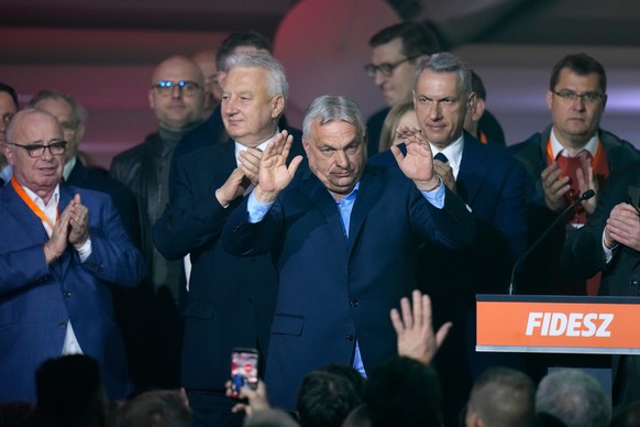 Hungary's Prime Minister Viktor Orban, center, flanked by his team reacts after a parliamentary election in Budapest, Hungary, Sunday, April 12, 2026. (AP Photo/Petr David Josek)
Viktor Orban