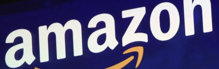 FILE - In this Friday, July 27, 2018 file photo, the logo for Amazon is displayed on a screen at the Nasdaq MarketSite. Amazon says it will stop accepting Visa credit cards issued in the United Kingdo ...