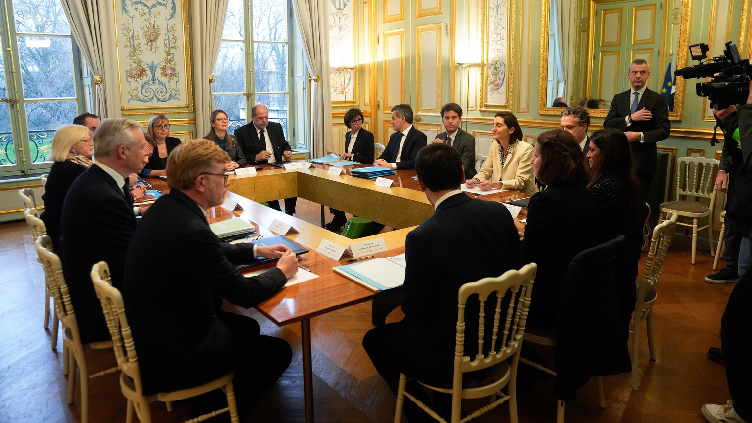epa11071132 New French prime minister Gabriel Attal, (C- background), attend the first meeting of the new cabinet after a cabinet reshuffle, at the Elysee Palace in Paris, France, 12 January 2024. EPA ...