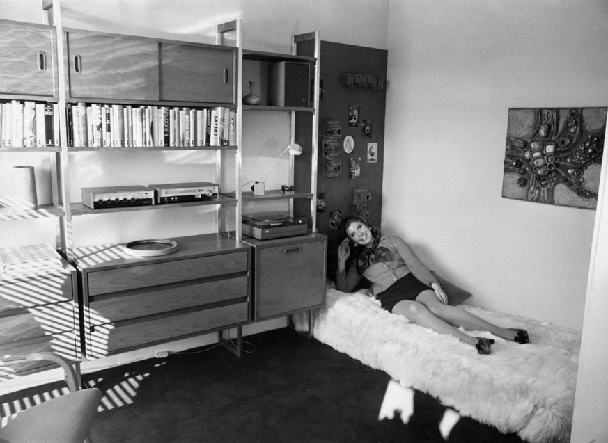 A woman posing on a sofa in the study of a modern one-bedroom flat in Speed House, the first residential block to be built on the Barbican Estate, London, October 21st 1968. (Photo by Ron Case/Keyston ...