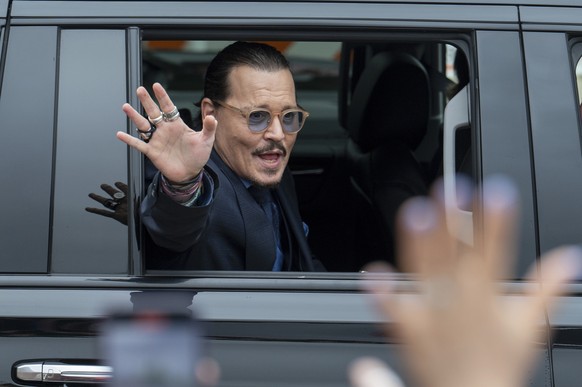 FILE - Actor Johnny Depp waves to supporters as he departs the Fairfax County Courthouse after closing arguments on May 27, 2022 in Fairfax, Va. Heard says she doesn
