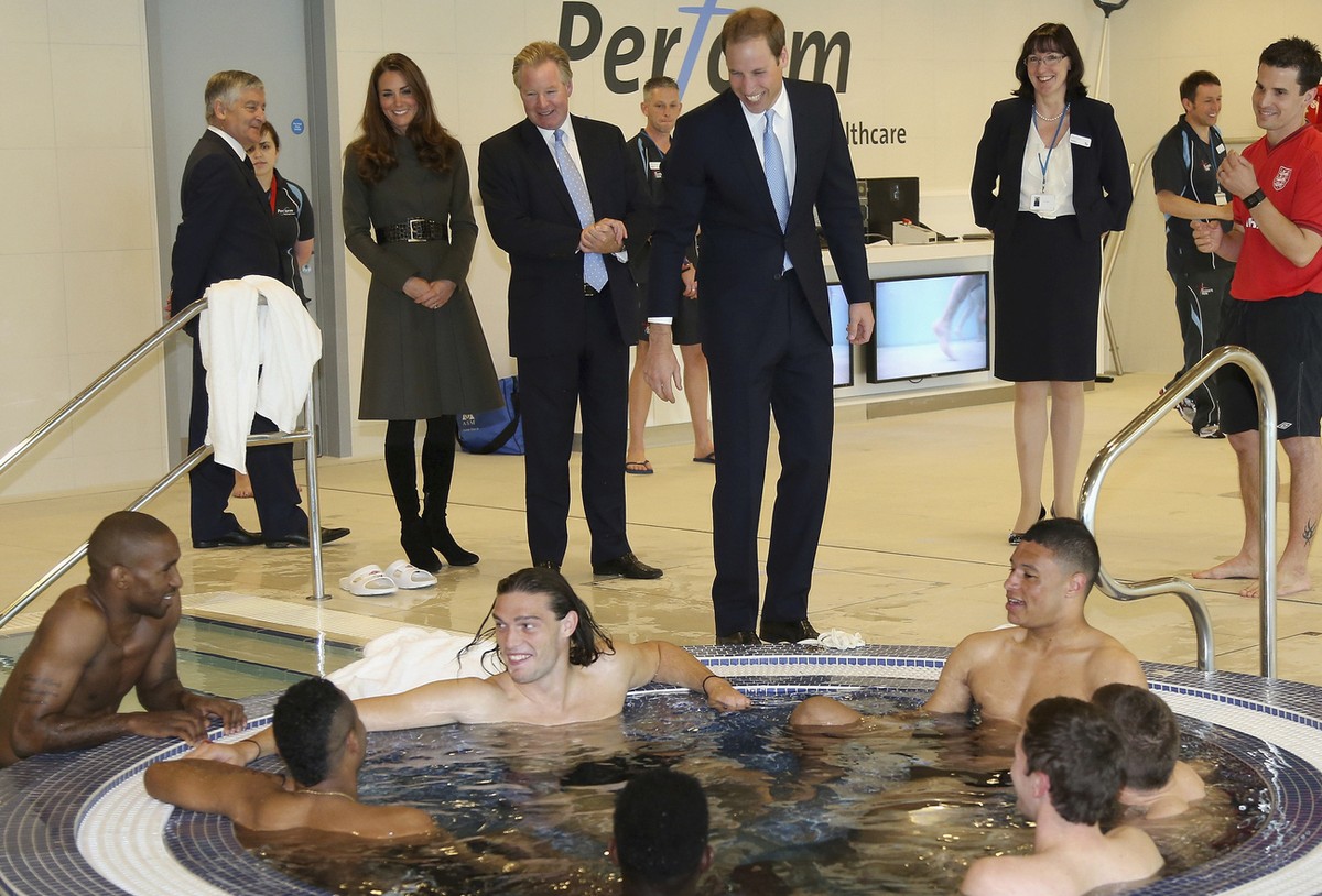 Britain's Prince William standing centre, talks England soccer players in the water at the hyrotherapy suite during the official launch of The Football Association's National Football Centre ...