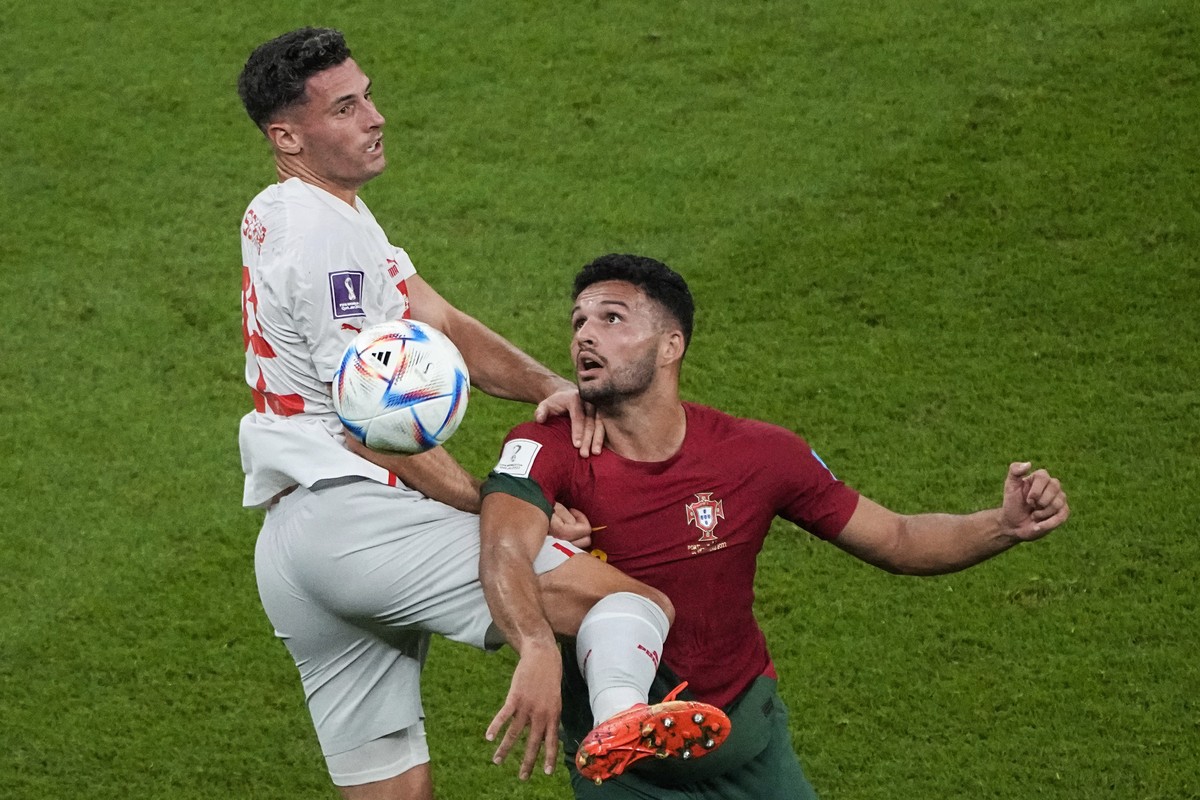 Switzerland's Fabian Schaer, left, and Portugal's Goncalo Ramos challenge for the ball during the World Cup round of 16 soccer match between Portugal and Switzerland, at the Lusail Stadium i ...
