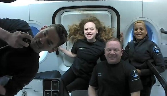 This photo provided by SpaceX shows the passengers of Inspiration4 in the Dragon capsule on their first day in space. They are, from left, Jared Isaacman, Hayley Arceneaux, Chris Sembroski and Sian Pr ...