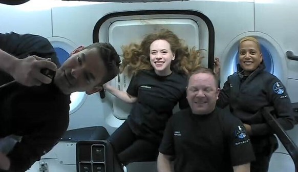 This photo provided by SpaceX shows the passengers of Inspiration4 in the Dragon capsule on their first day in space. They are, from left, Jared Isaacman, Hayley Arceneaux, Chris Sembroski and Sian Pr ...