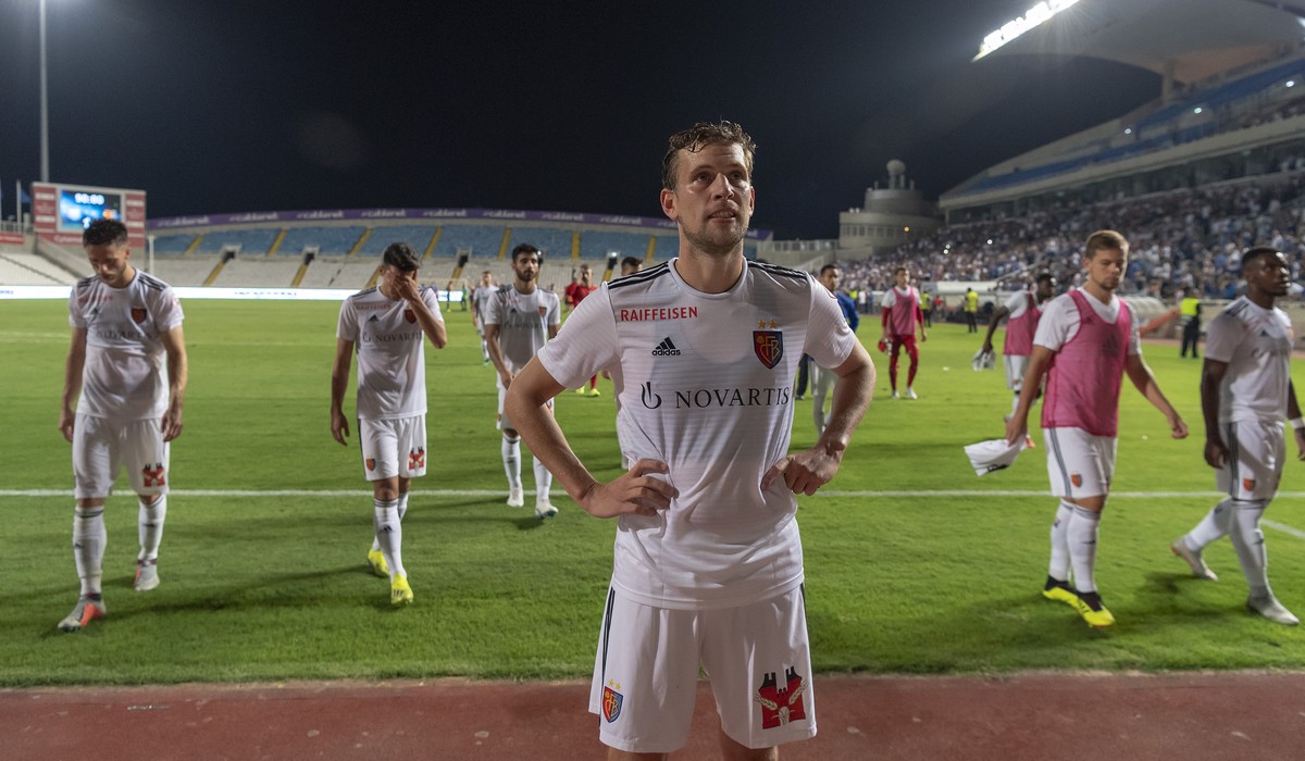 Basel's disappointed players with captain Fabian Frei, front, leave the pitch after the UEFA Europa League play-off second leg match between Cyprus' Apollon Limassol FC and Switzerland' ...