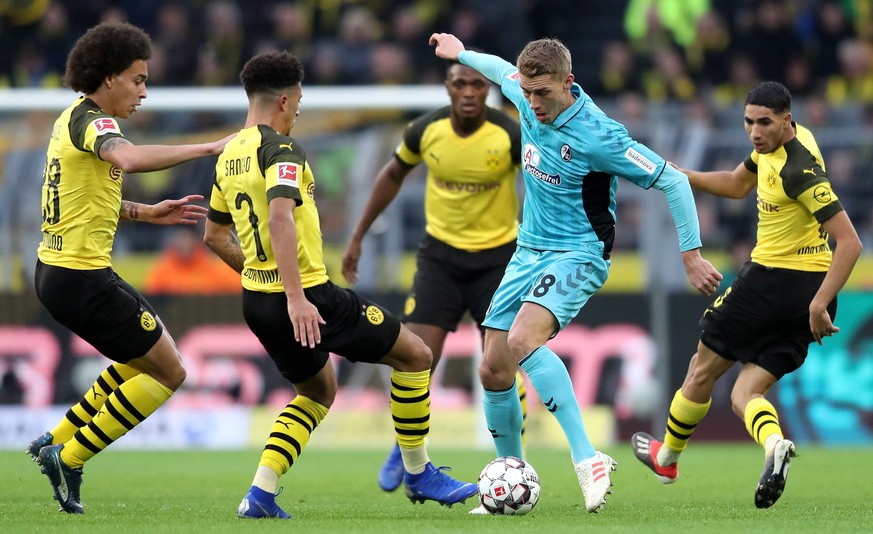 epa07201558 Dortmund&#039;s Axel Witsel (L), Dortmund&#039;s Jadon Sancho (2-L) and Dortmund&#039;s Achraf Hakimi (R) in action with Freiburg&#039;s Nils Petersen (2-R) during the German Bundesliga so ...