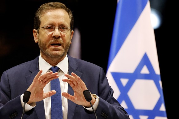 Israel&#039;s President Isaac Herzog delivers his speech during a tribute ceremony at the Halle aux Grains in Toulouse, southwestern France, Sunday, March 20, 2022. French President Emmanuel Macron an ...