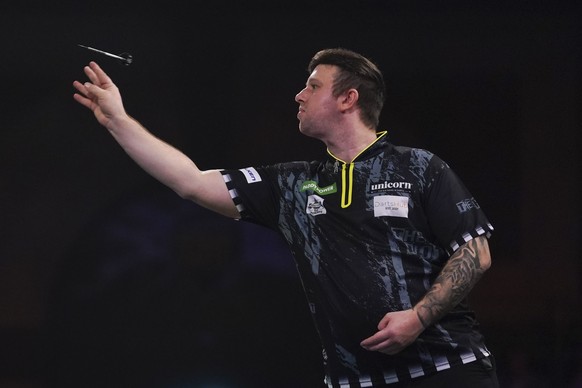 Callan Rydz of England in action during his quarter final match against Michael Van Gerwen of the Netherlands at the World Darts Championship in London, Wednesday, Jan. 1, 2025.(AP Photo/Alberto Pezza ...