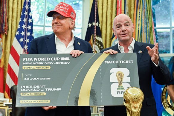 epa12317164 US President Donald Trump (L) and FIFA President Gianni Infantino (R) hold a ticket to the 2026 FIFA World Cup after after announcing the 2026 FIFA World Cup draw will be held at the Kenne ...