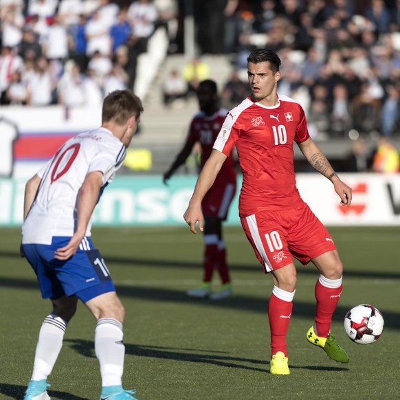 Faroe&#039;s Solvi Vatnhamar, left, fights for the ball against Switzerland&#039;s Granit Xhaka, right, during the 2018 Fifa World Cup Russia group B qualification soccer match between Switzerland and ...