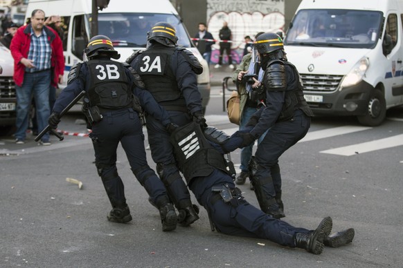 epaselect epa05802430 An unconscious riot police officer is dragged by fellow officers after he received a rock on the head, as clashes erupt during a demonstration to support Theo and against police  ...