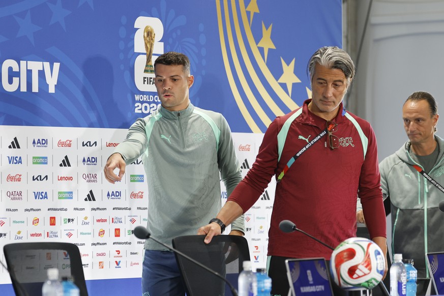 Switzerland's captain Granit Xhaka, head coach Murat Yakin, and Adrian Arnold, chief communication Swiss Football Federation SFV, from left, attend a press conference one day ahead of the World C ...