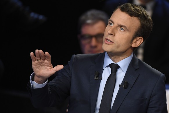 epa05888874 French presidential election candidate for the En Marche! movement Emmanuel Macron gestures as he speaks during a debate organised by the French private TV channels BFM TV and CNews, betwe ...
