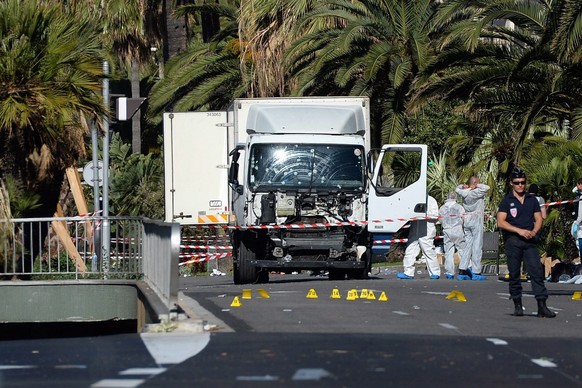 epa05426298 Police secure the area where a truck drove into a crowd during Bastille Day celebrations in Nice, France, 15 July 2016. According to reports, at least 84 people died and many were injured ...