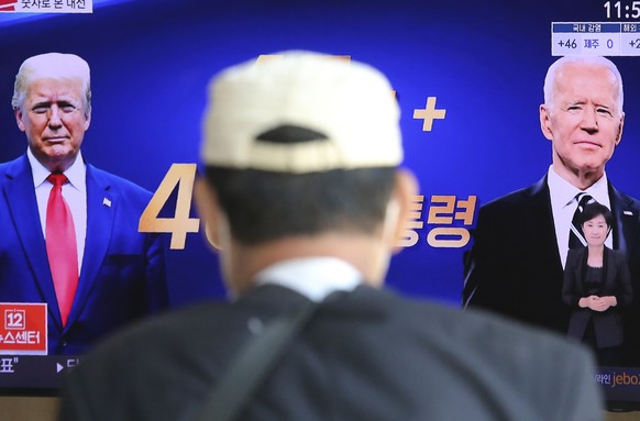 A TV screen shows images of U.S. President Donald Trump, left, and Democratic presidential candidate former Vice President Joe Biden during a news program at the Seoul Railway Station in Seoul, South  ...