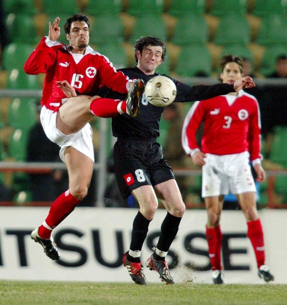 Georgia&#039;s Levan Kobiashvili, center, is fighting for the ball between Swiss Fabio Celestini, left, and Bruno Berner, right, during their Euro 2004 qualifying match, group 10, Georgia vs Switzerla ...