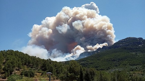 In this photo released by Agents Rurals de Catalunya, uncontrolled fire rages across the forrest in Pauls, in the rural province of Tarragona , Spain, Tuesday, July 8, 2025. (Agents Rurals de Cataluny ...