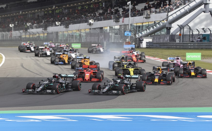 epa08735366 British Formula One driver Lewis Hamilton of Mercedes-AMG Petronas (C-L) and Finnish Formula One driver Valtteri Bottas of Mercedes-AMG Petronas (C-R) in action in turn 1 lap 1 after the s ...