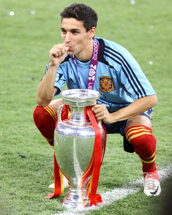 KYIV, UKRAINE - JULY 1, 2012: Jesus Navas of Spain poses for a photo with Trophy after UEFA EURO 2012 Final game against Italy at Olympic stadium in Kyiv. Spain won the game and the Tournament xkwx Je ...