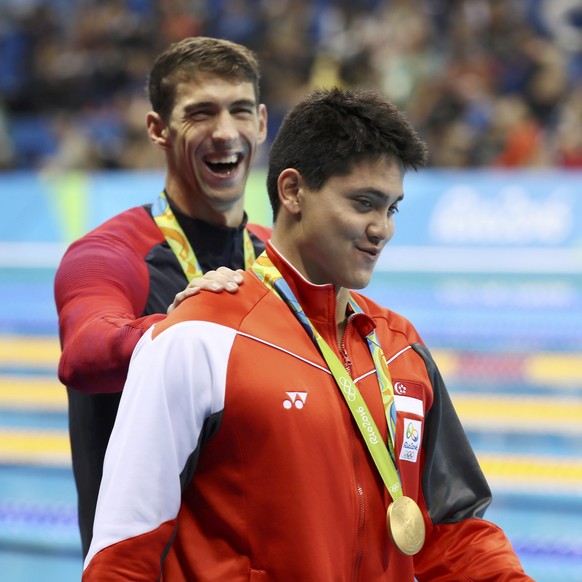 2016 Rio Olympics - Swimming - Victory Ceremony - Men&#039;s 100m Butterfly Victory Ceremony - Olympic Aquatics Stadium - Rio de Janeiro, Brazil - 12/08/2016. Joseph Schooling (SIN) of Singapore is co ...