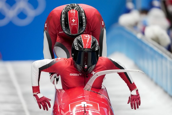 Michael Vogt and Sandro Michel, of Switzerland, slide during the 2-man heat 1 at the 2022 Winter Olympics, Monday, Feb. 14, 2022, in the Yanqing district of Beijing. (AP Photo/Pavel Golovkin)