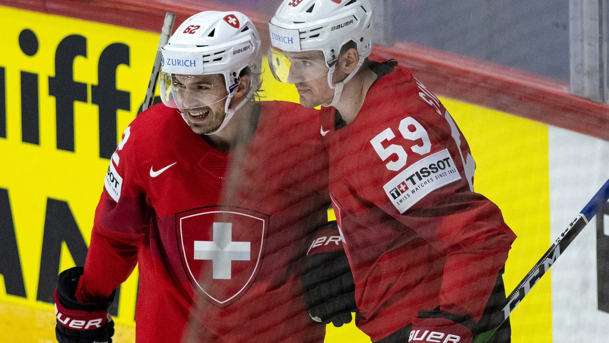 epa09953543 Switzerland's Dario Simion (R) and Denis Malgin celebrate their second goal during the Ice Hockey World Championship group A preliminary round match between Switzerland and Kazachstan ...