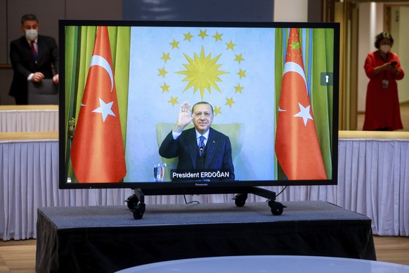 Turkey&#039;s President Recep Tayyip Erdogan waves from the video monitor as he participates in a video conference with European Commission President Ursula von der Leyen and European Council Presiden ...