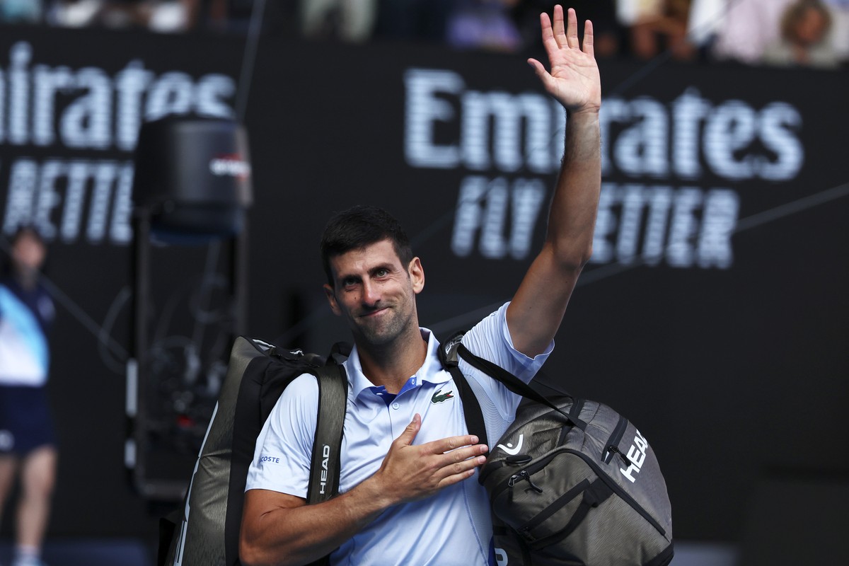 Novak Djokovic of Serbia waves as he leaves Rod Laver Arena after his loss to Jannik Sinner of Italy in their semifinal at the Australian Open tennis championships at Melbourne Park, Melbourne, Austra ...