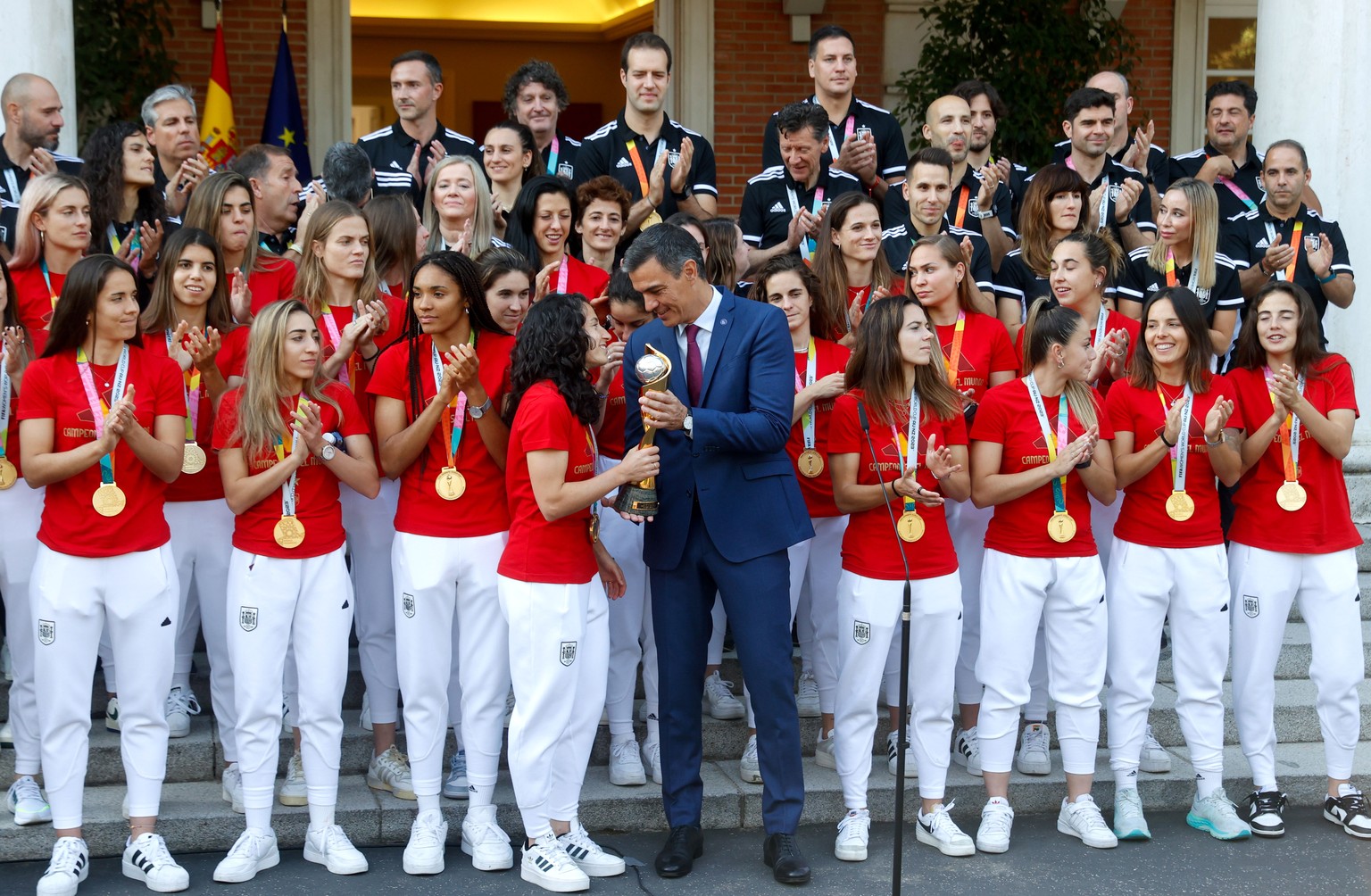 epa10813108 Spanish acting Prime Minister Pedro Sanchez (C-R) chats with captain of the Women&#039;s Spanish National Soccer Team Ivana Andres (C-L) as he welcomes the team as world champions at Moncl ...