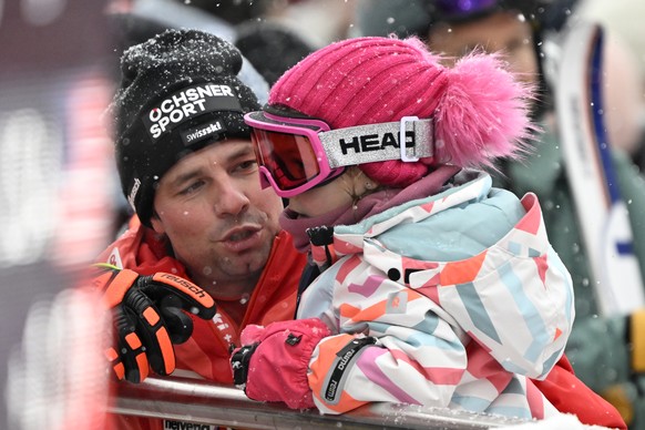 Switzerland&#039;s Beat Feuz and his daughter Clea in the finish area during the men&#039;s downhill race at the Alpine Skiing FIS Ski World Cup in Kitzbuehel, Austria, Saturday, January 21, 2023. (KE ...