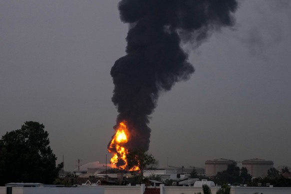 Fire and plumes of smoke rises after a drone struck a fuel tank forcing the temporary suspension of flights. near Dubai International Airport, in United Arab Emirates, early Monday, March 16, 2026. (A ...