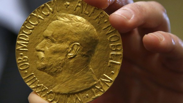 Bidder Ole Bjorn Fausa, of Norway, holds the 1936 Nobel Peace Prize in Baltimore, Thursday, March 27, 2014, the second Nobel Peace Prize ever to come to auction. The prize sold for a winning bid of $9 ...